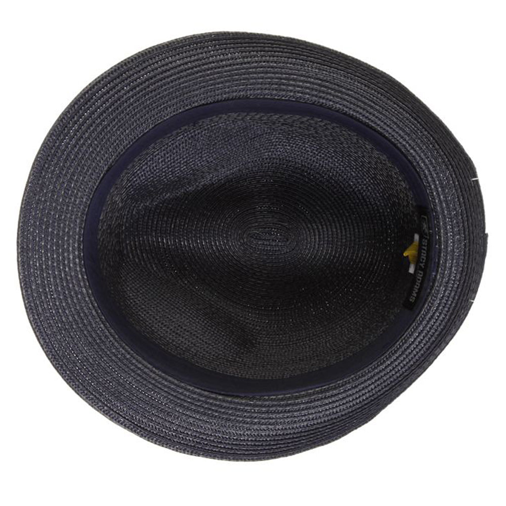 Underside of a navy blue colored fedora hat with thick darker navy blue band with blue, white, and black feather tucked in and a black and silver Stacy Adams pin below it
