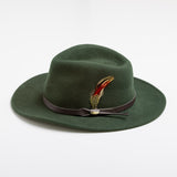 Pine colored fedora hat with a feather and brown band on a white background
