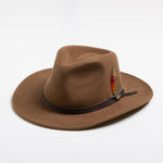 Pecan colored fedora hat with a brown band and feather on a white background