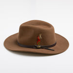 Pecan colored fedora hat with a brown band and feather on a white background