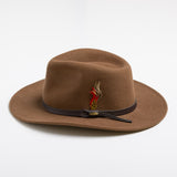 Pecan colored fedora hat with a brown band and feather on a white background