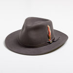 Gray fedora hat with a feather on a white background