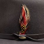Feathered hat band with red and yellow feathers on a gray felt hat, featuring a gold Scala brand logo on the brown band