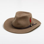 Tan fedora hat with a brown band and red feather on a white background