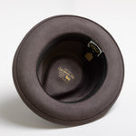 Gray felt hat with a brand label on a white background