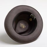 Gray felt hat with a brand label on a white background