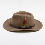 Tan fedora hat with a feather on a white background