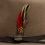 Tan hat with a feather and gold Scala logo on a brown trim