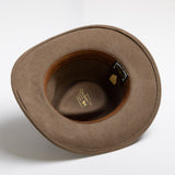 Tan hat with a visible brand label on a white background