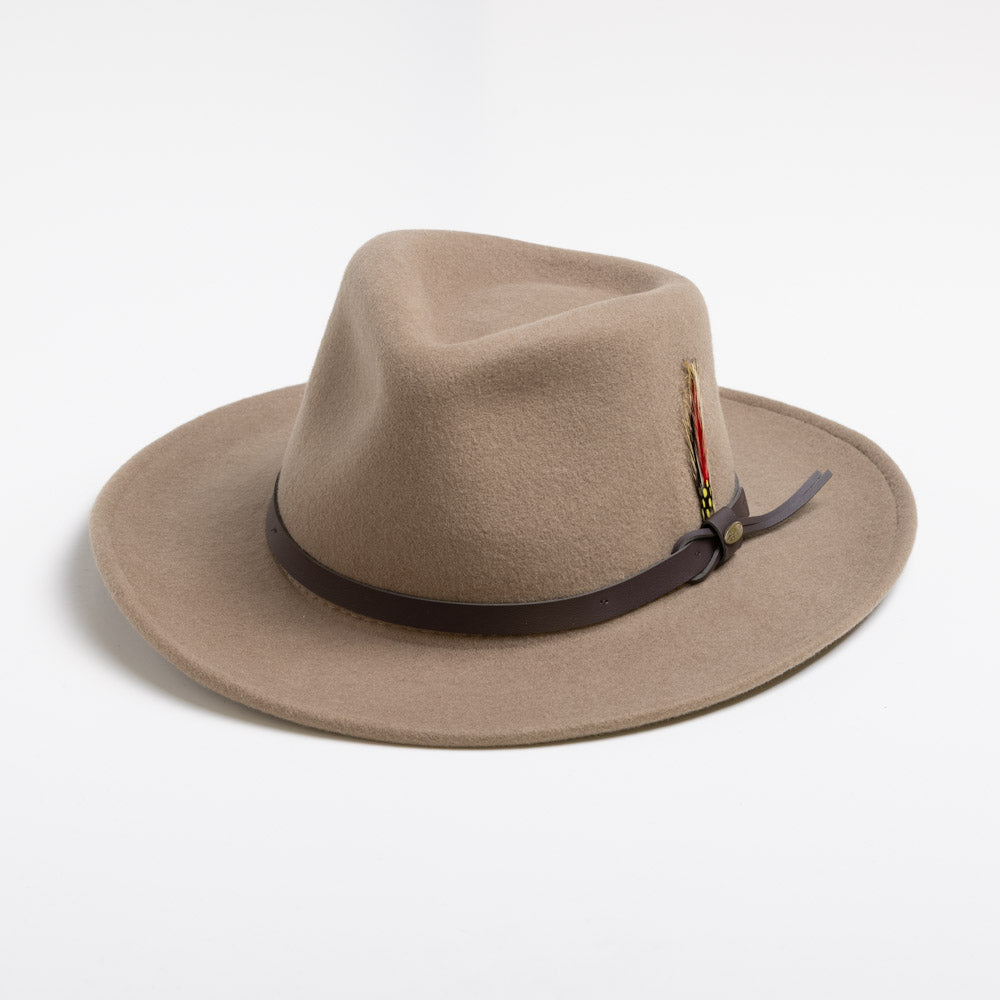 Putty colored fedora hat with a feather and brown band on a white background