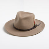 Putty colored fedora hat with a feather and brown band on a white background