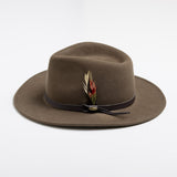 Khaki colored fedora hat with a feather and brown band on a white background
