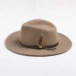 Putty colored fedora hat with a feather and brown band on a white background