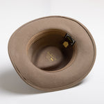 Putty colored hat with a visible brand tag on a white background