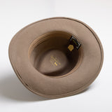 Putty colored hat with a visible brand tag on a white background