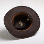 Chocolate colored hat with a visible brand label on a white background