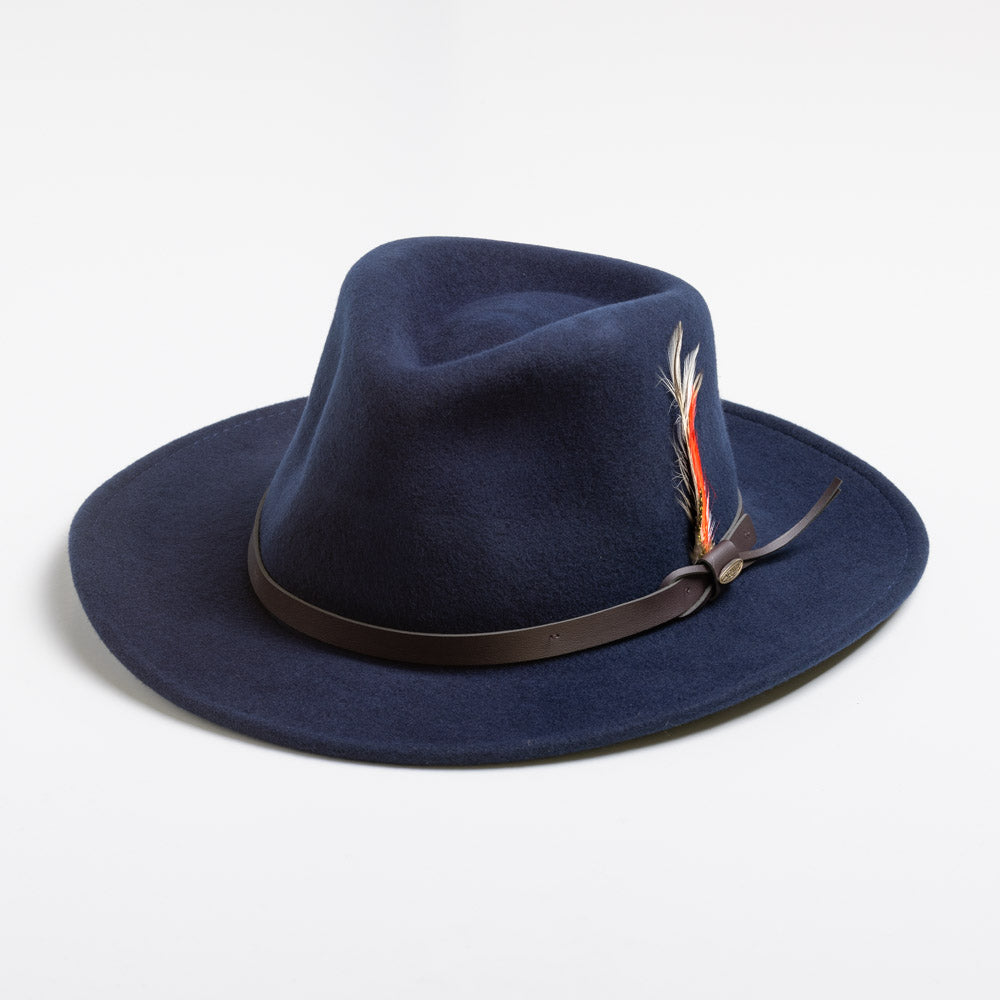 Navy blue fedora hat with a feather on a white background