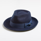 Navy blue fedora hat with a ribbon on a light gray background