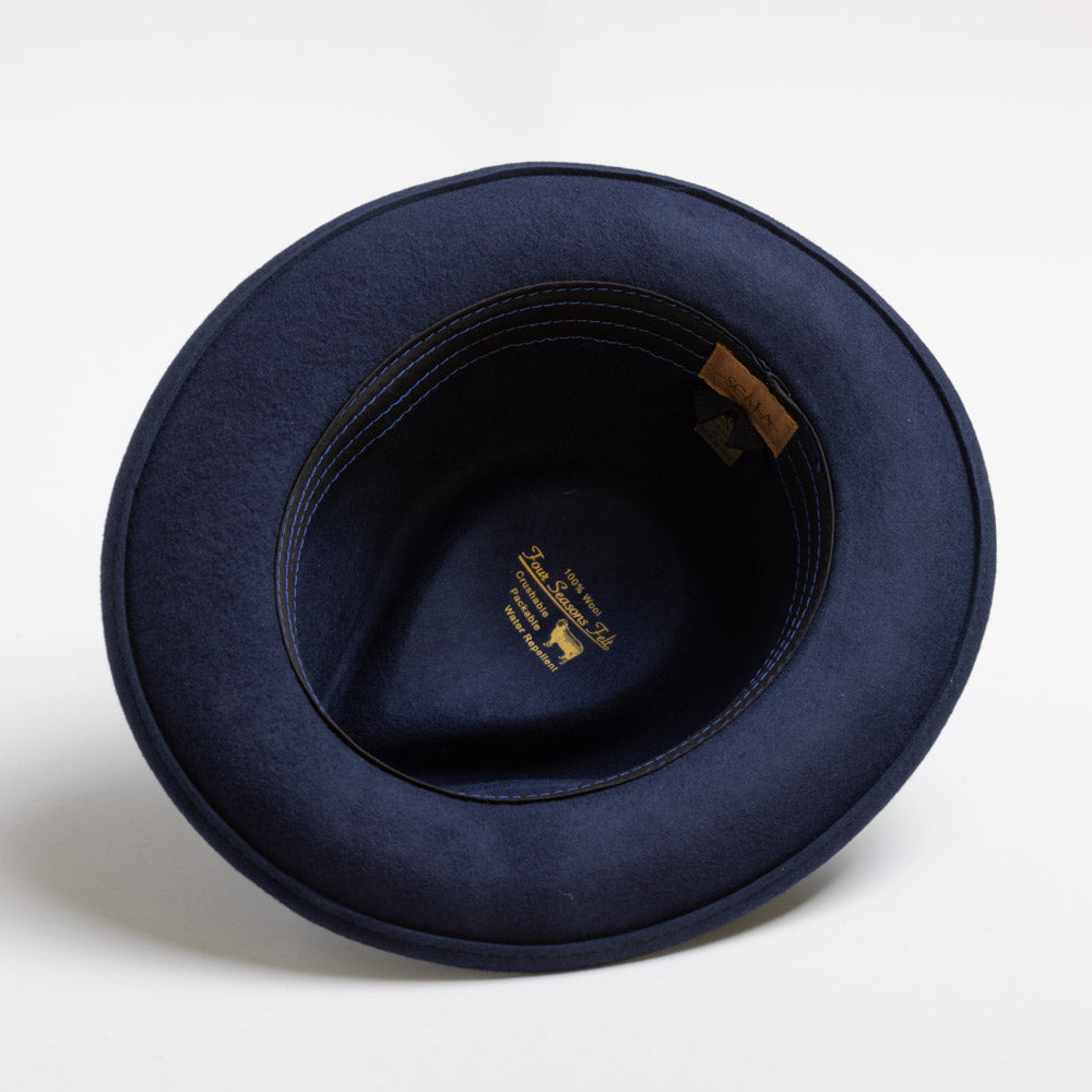 Navy blue fedora hat with a brand label on a white background