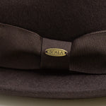 Chocolate brown hat fabric with a bow and Scala logo on a matching background