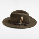 Olive colored fedora hat with a feather and brown band on a white background