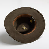 Olive colored hat with a visible brand label on a white background