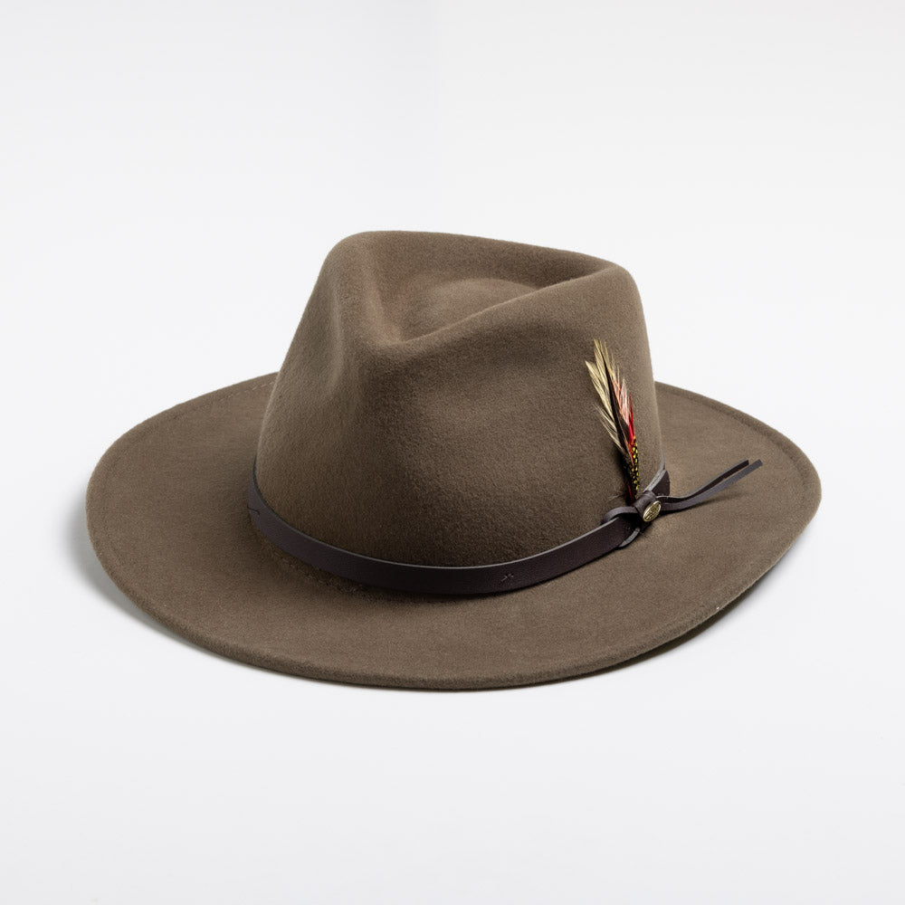 Khaki colored fedora hat with a feather on a white background